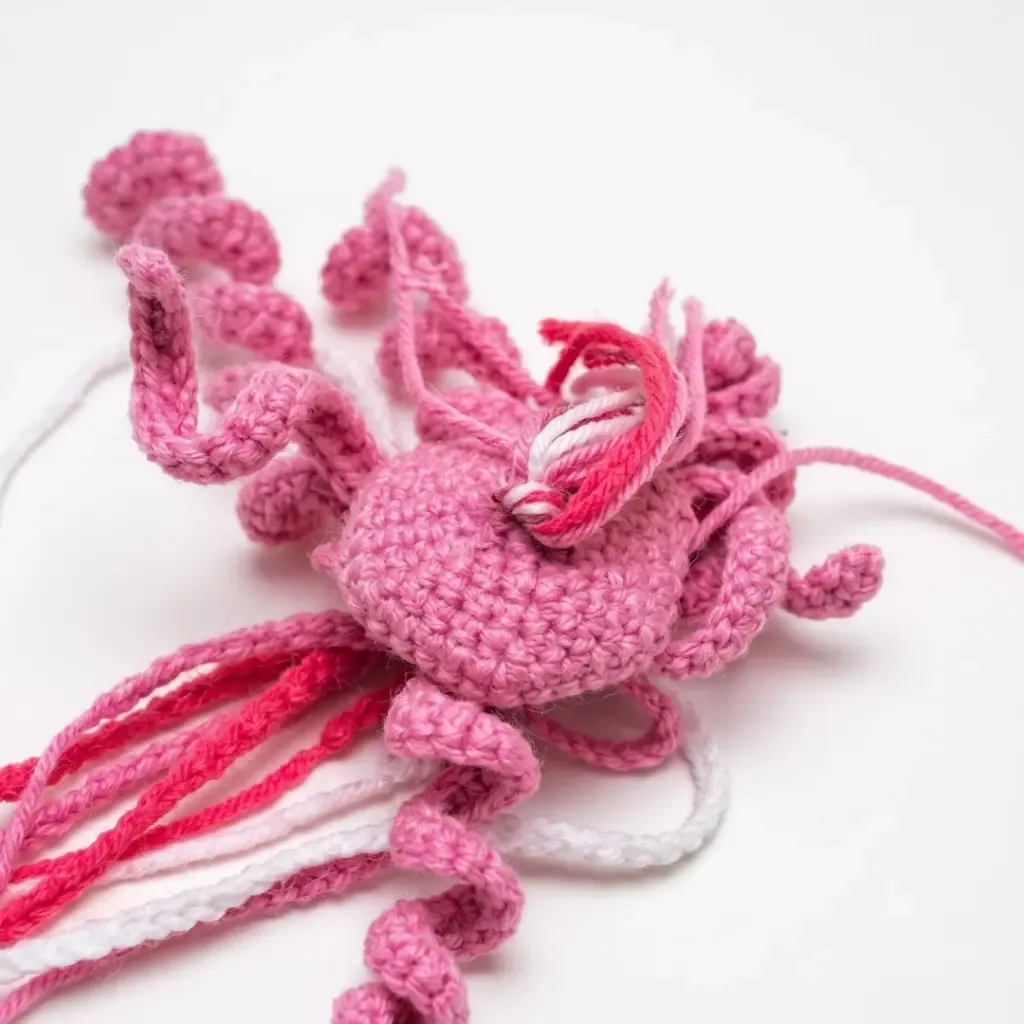 Jellyfish amigurumi with curly tentacles and a domed cap